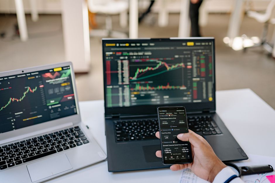 A market participant monitors multiple trading screens as new equity supply tests liquidity.