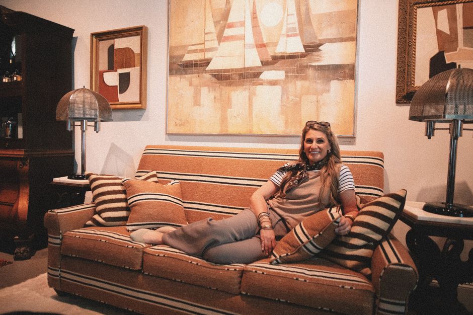 A warm living-room setting represents the physical retail and big-ticket spending exposure in the consumer half of the thesis.