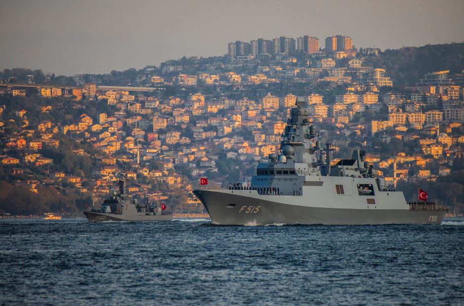 Naval warships sailing through a narrow strait, illustrating military presence at maritime chokepoints.