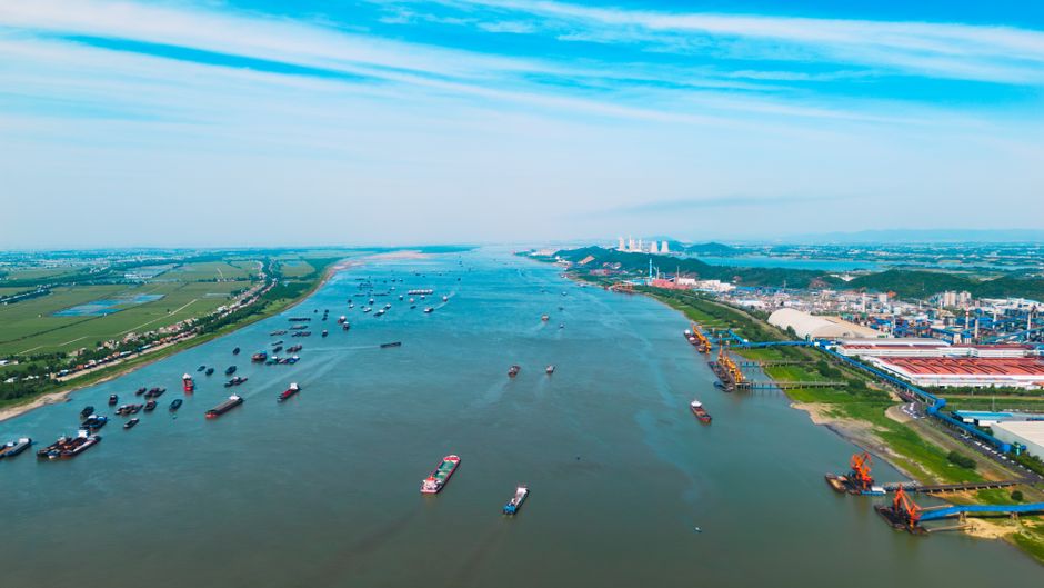 Cargo ships traveling through a busy commercial waterway, representing the shipping routes central to the oil-supply shock.