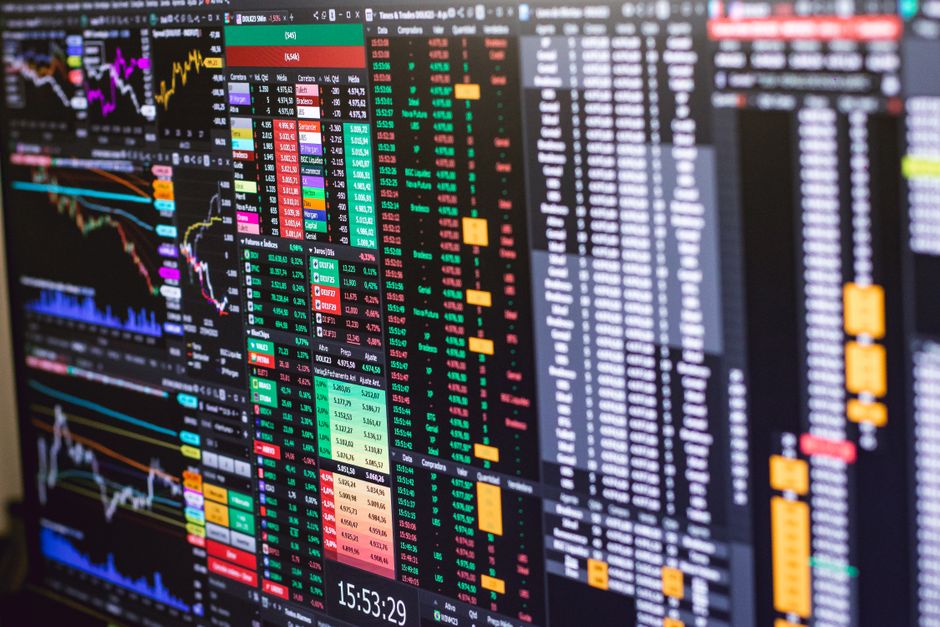 Electronic market data screens showing charts and price information during equity trading