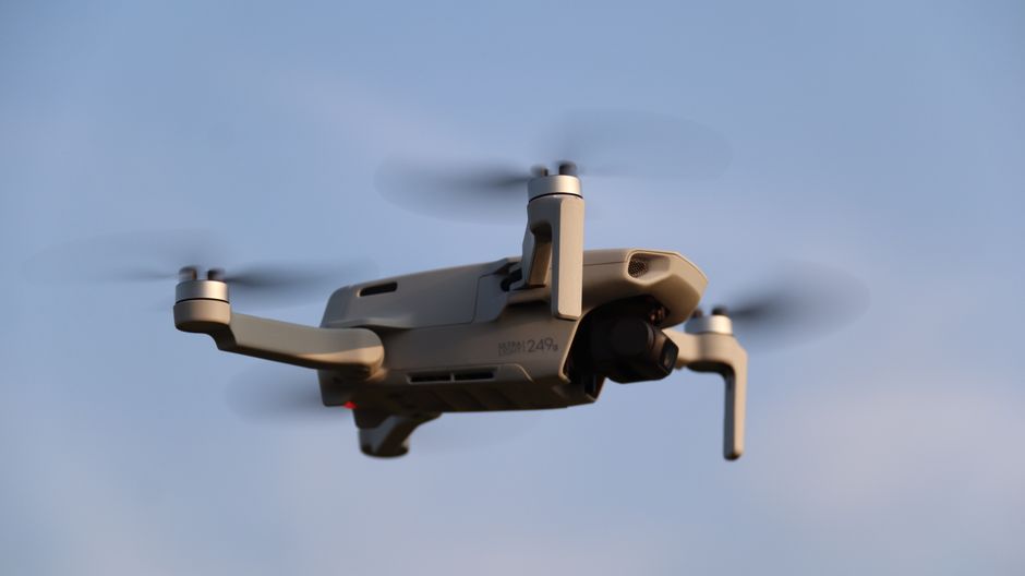 A drone in flight against a clear blue sky, representing the drone and missile warfare now defining both the Hormuz and Black Sea confrontations.