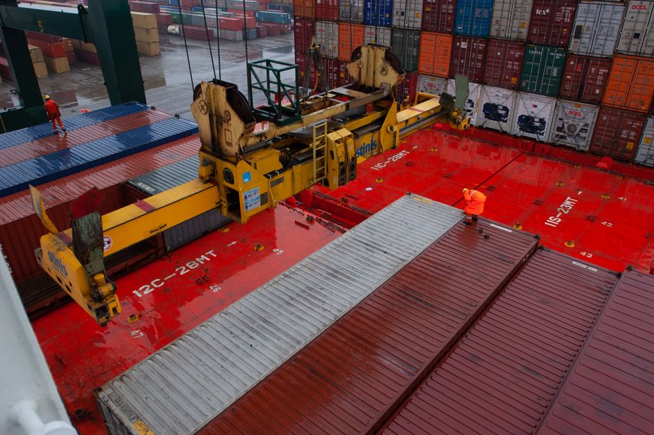 Gantry crane loading cargo containers at a port