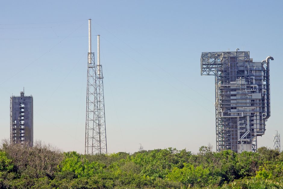 View of rocket launch gantry towers at Kennedy Space Center under a clear sky.