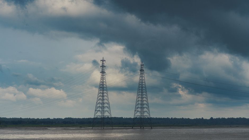 High-voltage transmission infrastructure represents the power demands of the expanding AI buildout.
