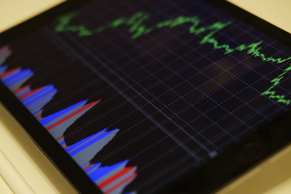 Stock-market graph displayed on a tablet, representing liquidity analysis and public-equity price formation.