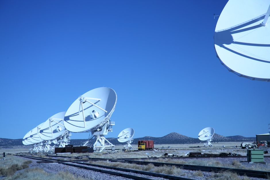 Satellite dish array under blue sky