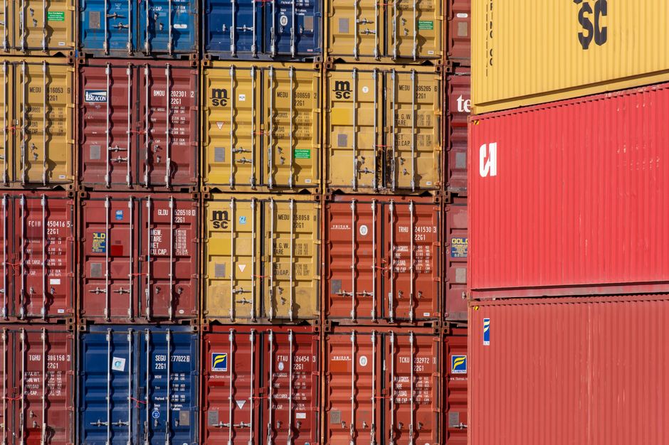 Colorful shipping containers stacked in a port terminal for transport logistics
